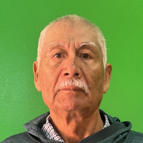 Candido R. in a close-up portrait, with a white mustache, looking directly at the camera