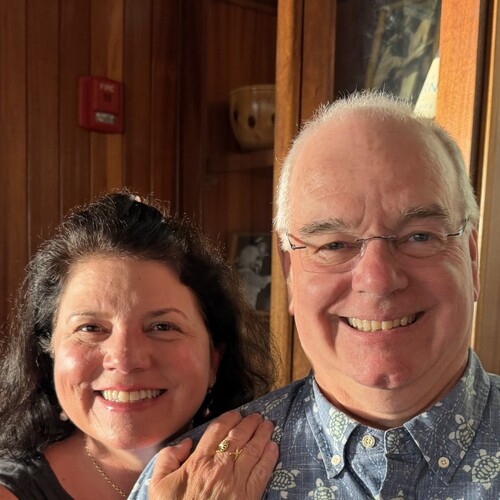 Christine and Lenny Mendonca smiling together indoors